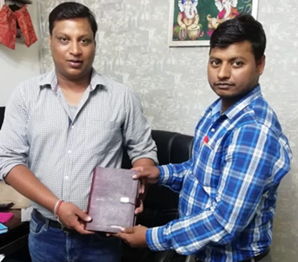 Two men holding a leather folder