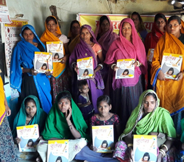 Group of women holding educational booklets