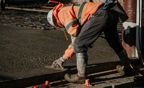 Man flattening cement